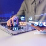 A,Person,Is,Using,A,Laptop,To,Check,Tax,Compliance